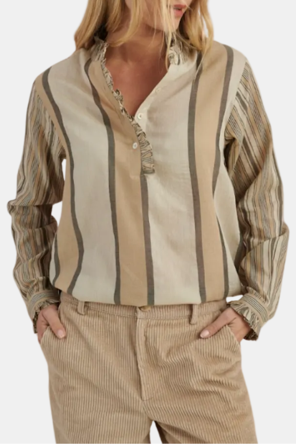 Woman wearing a patterned blouse and beige pants on a white background