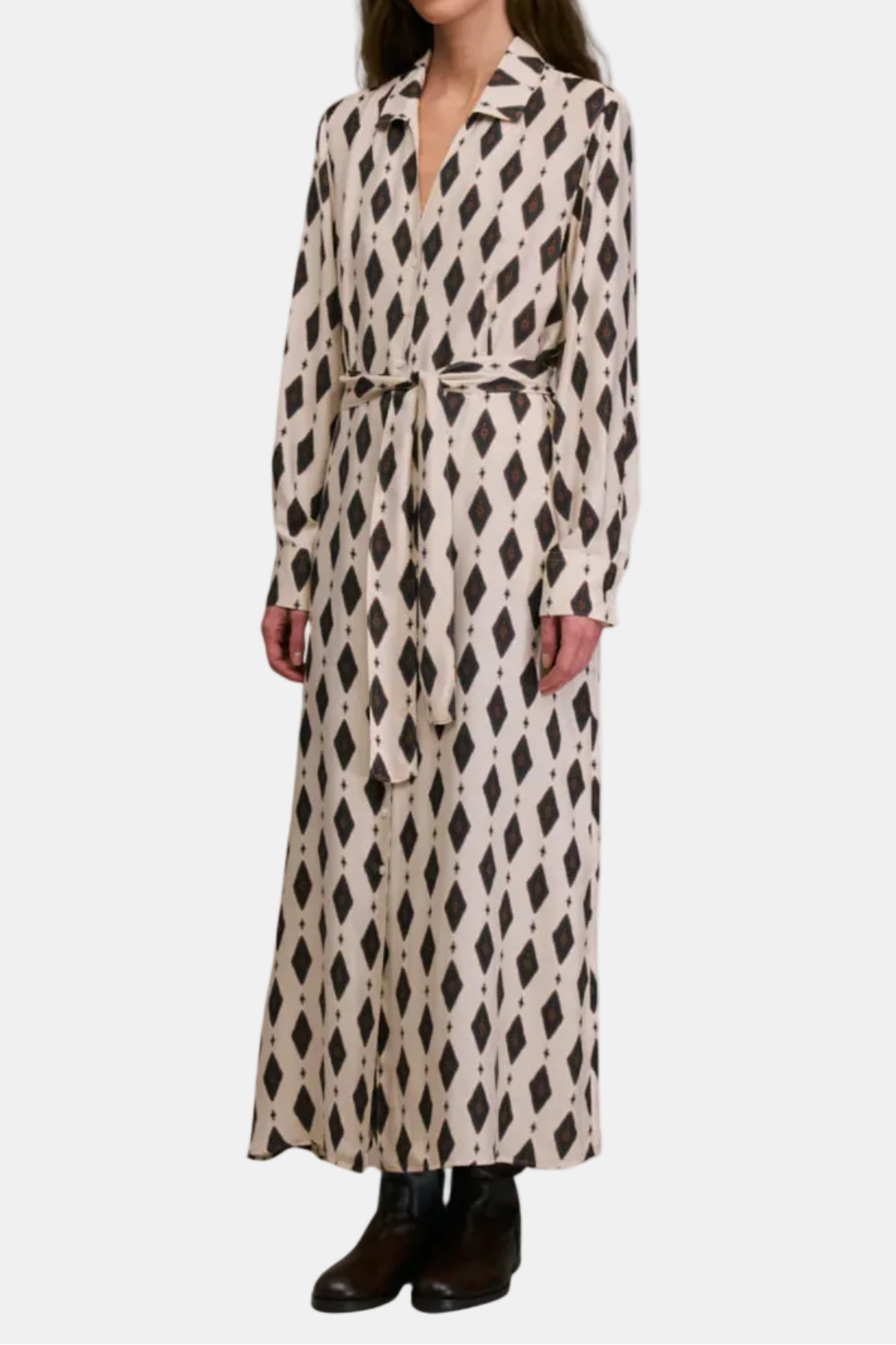 Woman wearing a long, patterned dress on a white background
