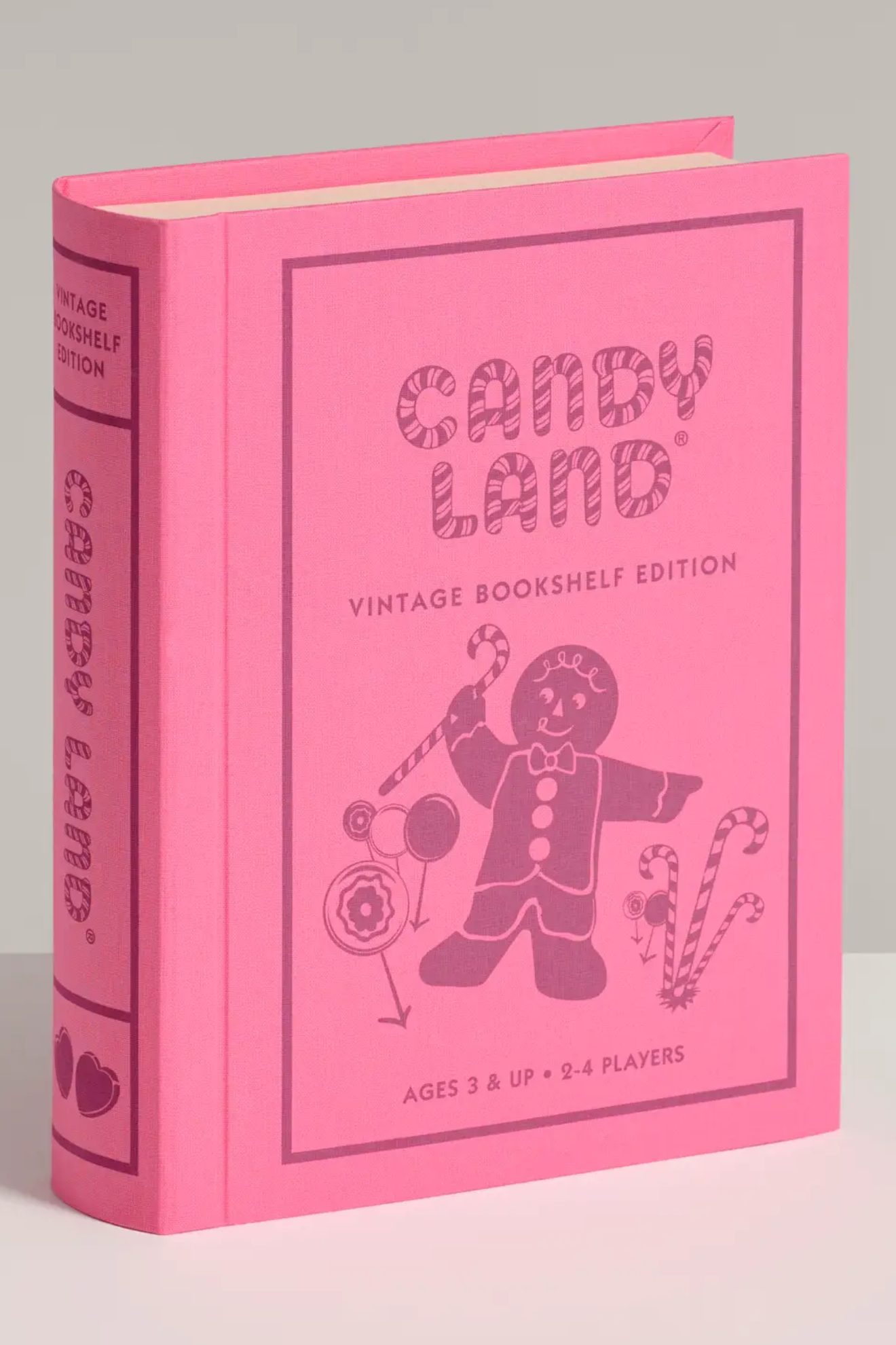Pink 'Candy Land' vintage bookshelf edition packaging on a gray background