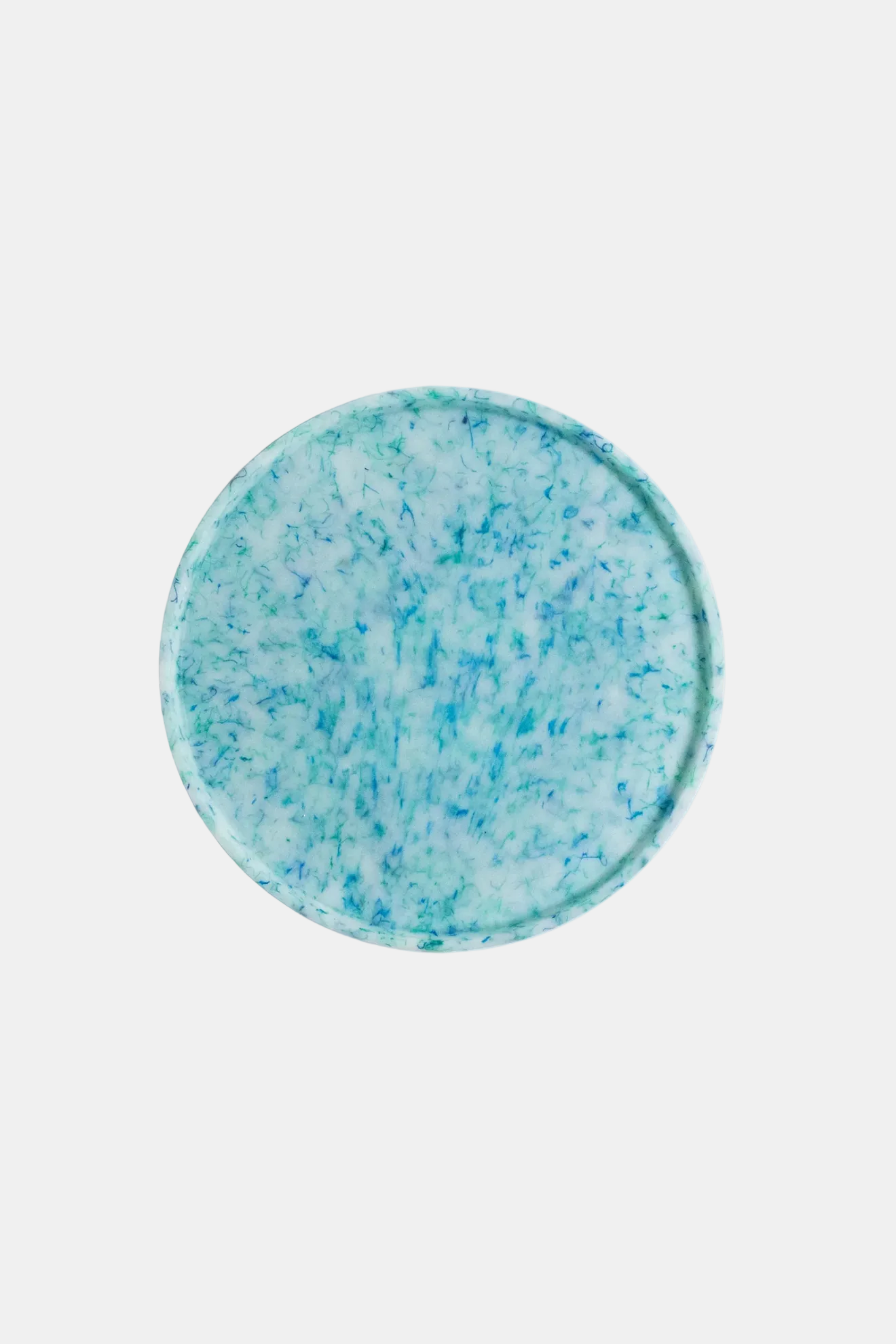Round blue and white speckled object on a white background