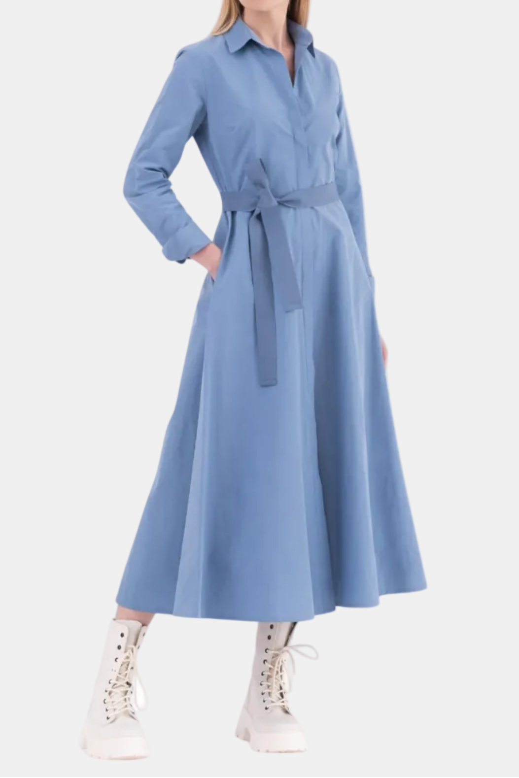 Woman wearing a blue dress with a belt on a white background