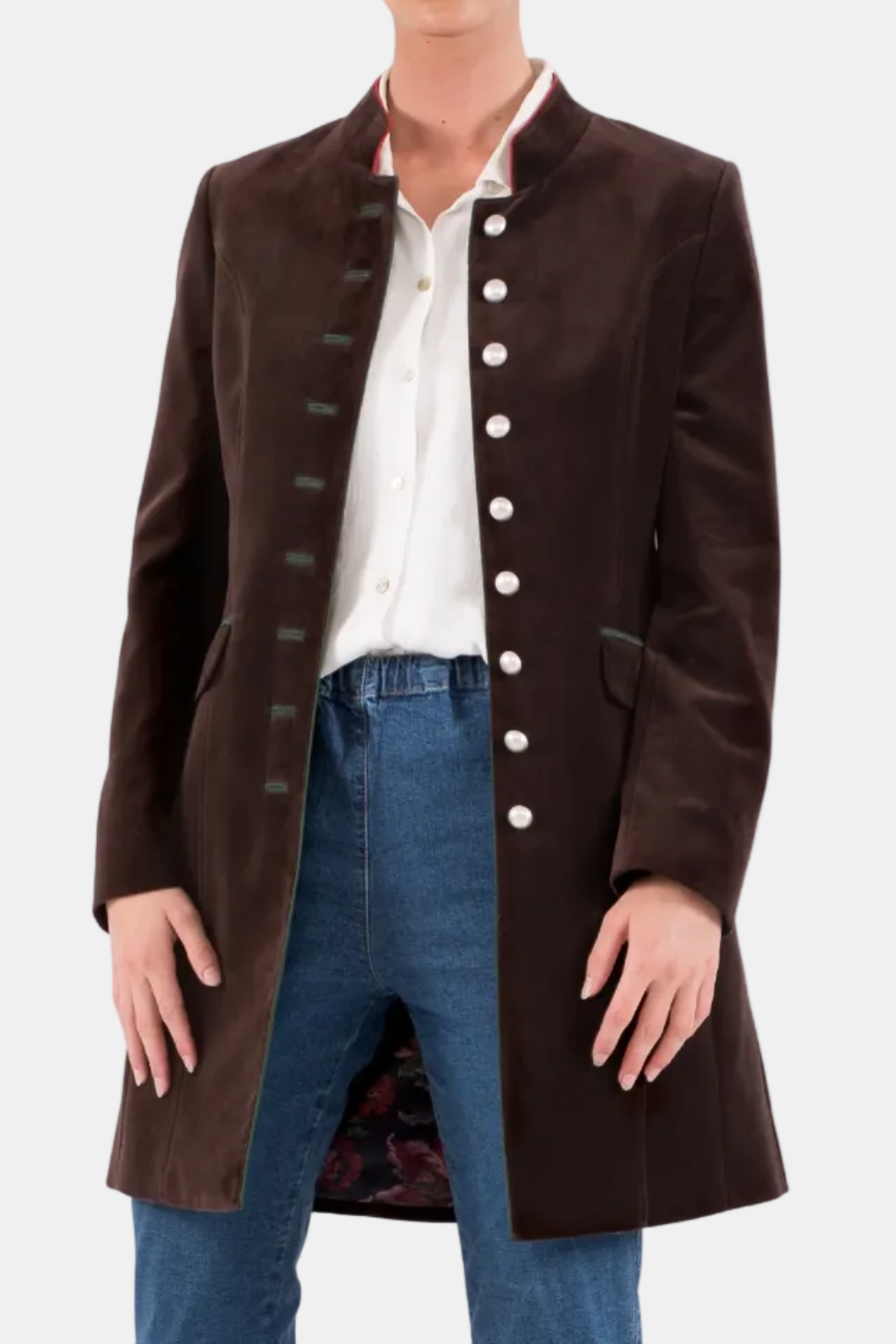 Woman wearing a brown coat with white buttons on a white background