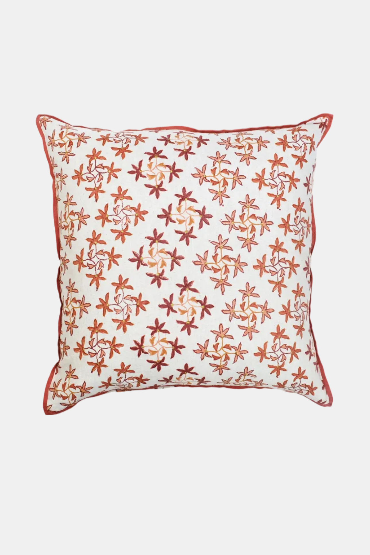 Decorative pillow with red floral pattern on a white background