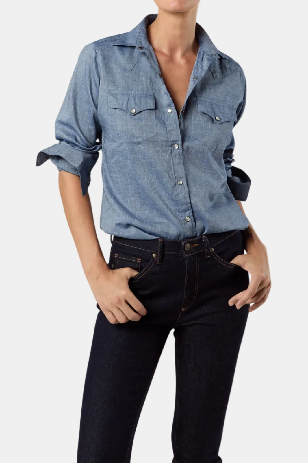 Woman wearing a blue denim shirt and black jeans on a white background