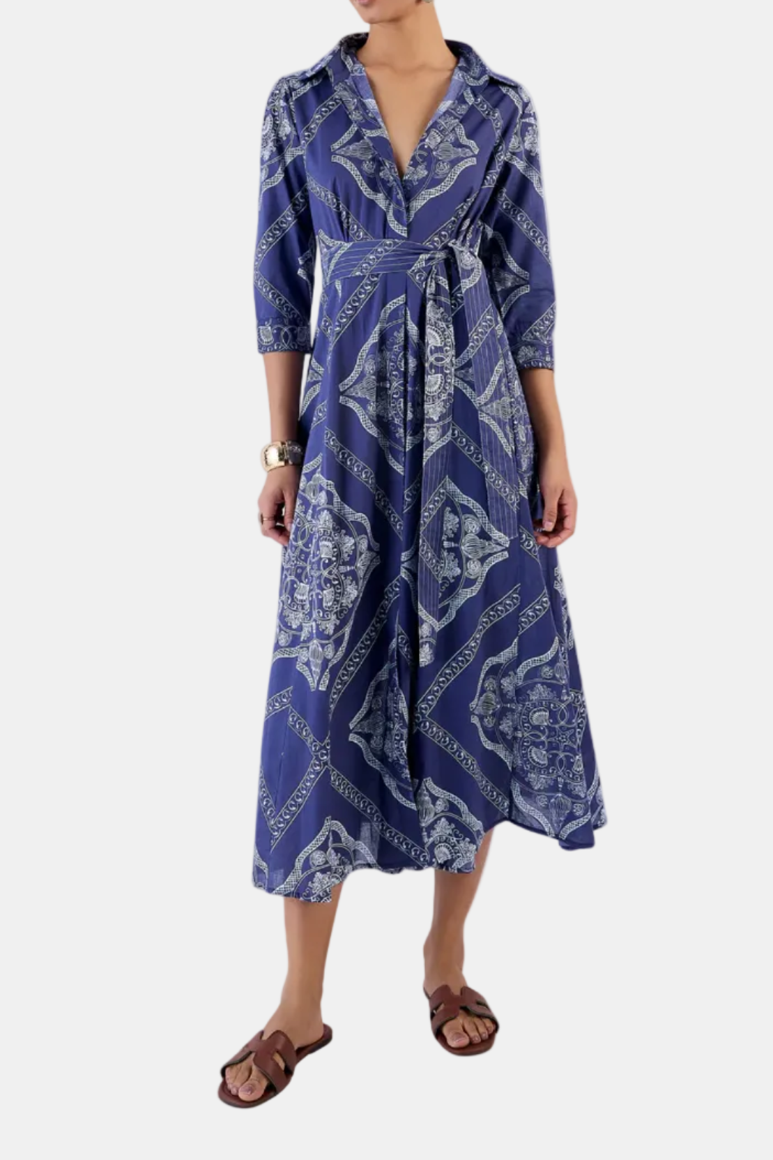 Woman wearing a blue patterned dress on a white background