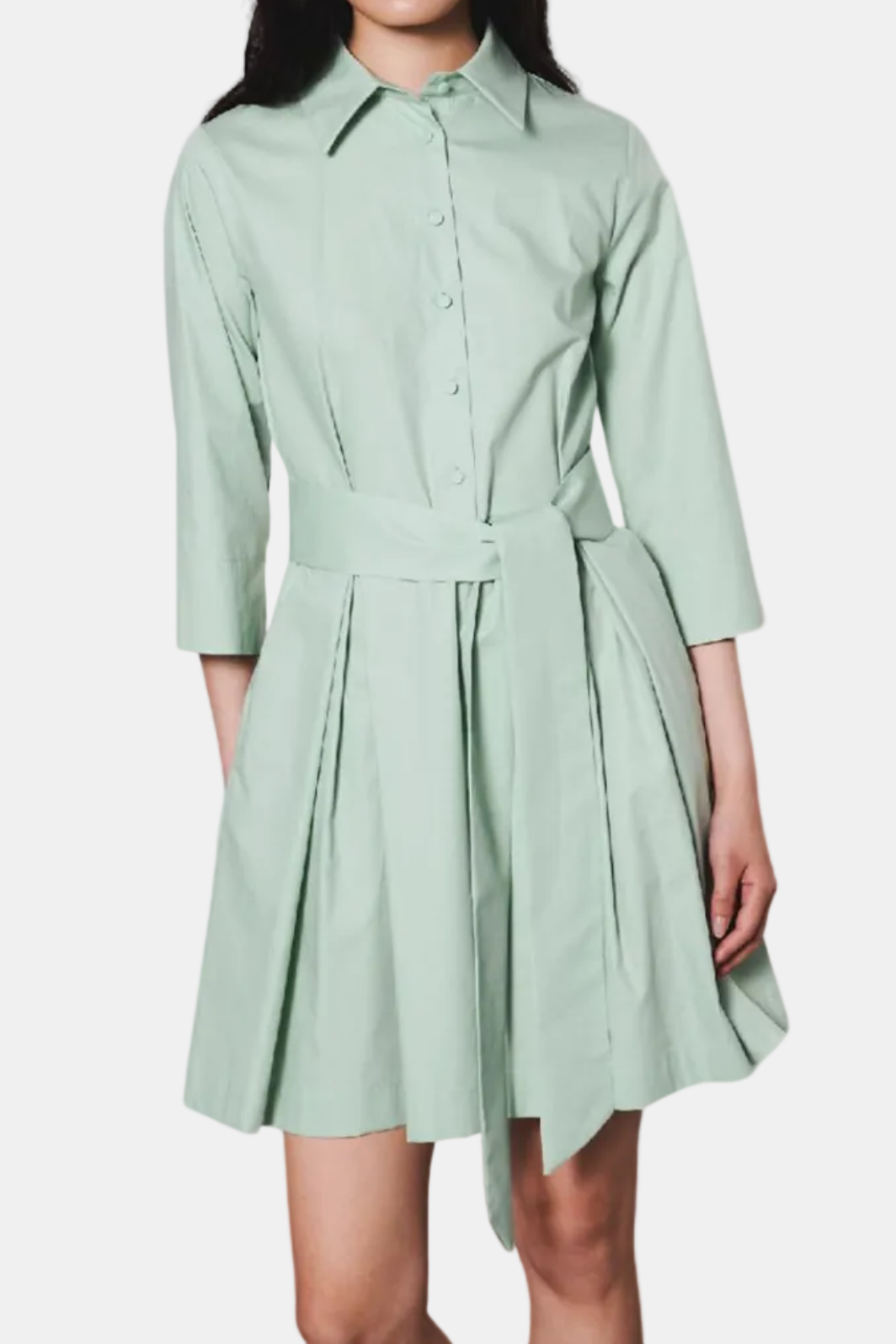 Woman wearing a light green dress on a white background