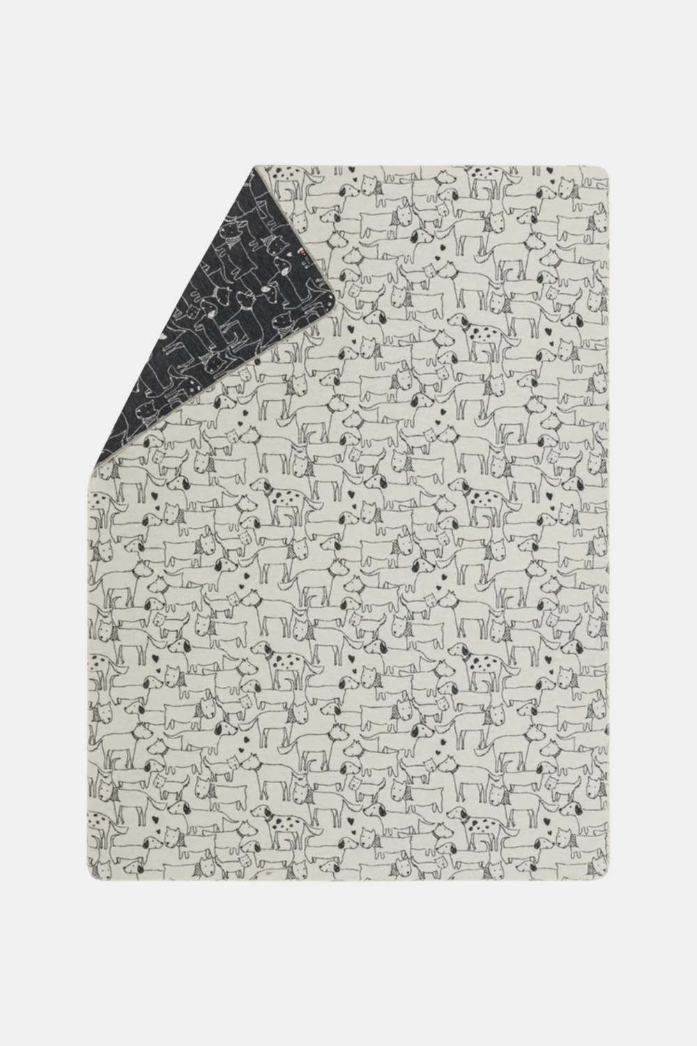 A rectangular baby blanket or mat with a black and white dog pattern, shown flat with one corner folded over to reveal the reverse side, on a light gray background.