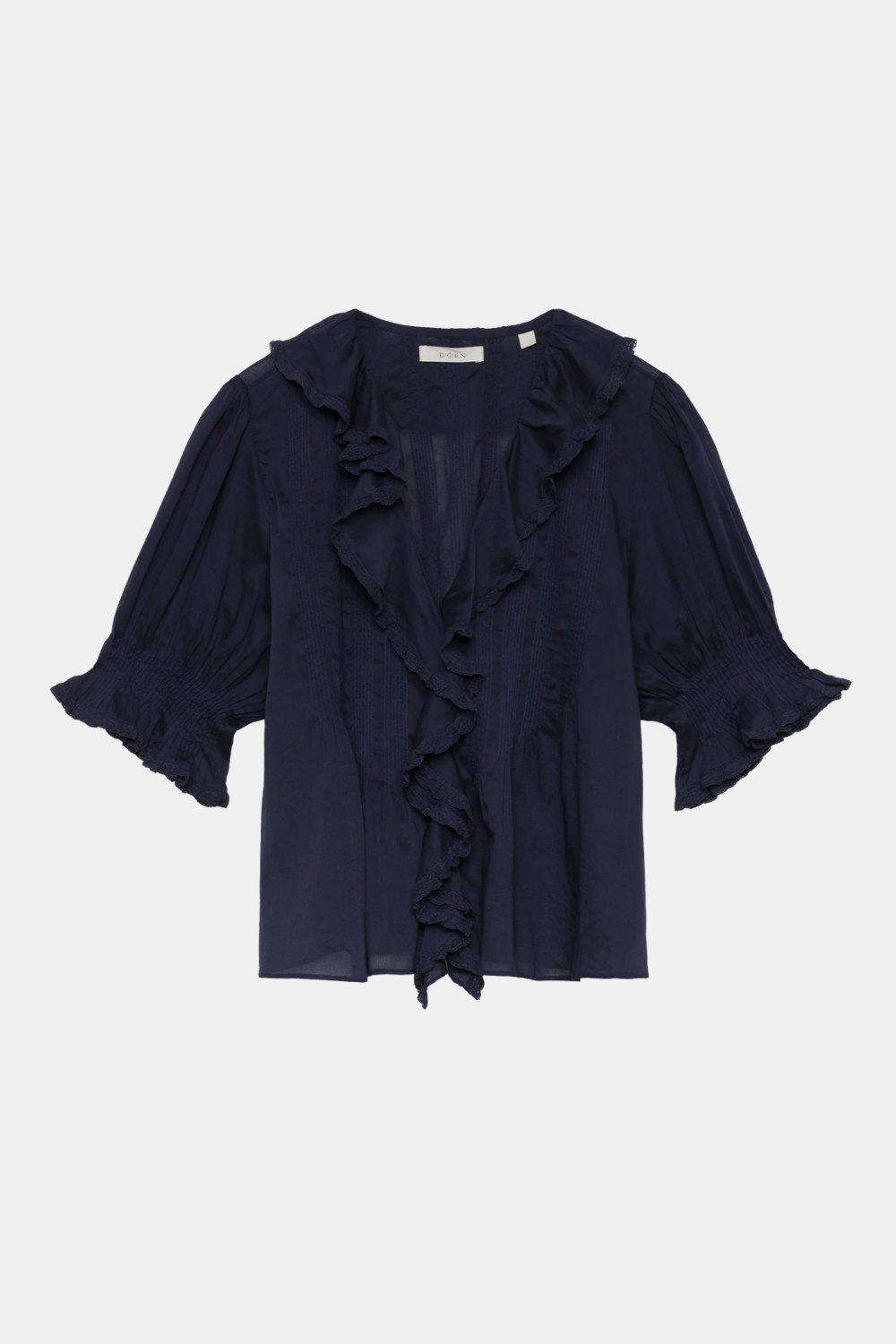 A navy blue ruffled blouse with three-quarter sleeves and a ruffled front overlay, displayed flat against a light gray background.