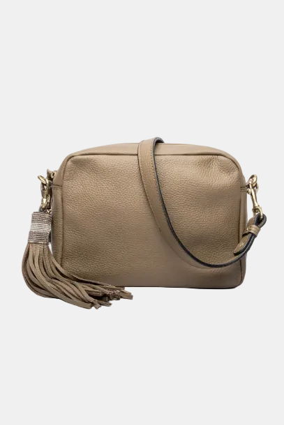 A brown leather handbag with a long shoulder strap, a tassel on the zipper, and a detachable shoulder strap.
