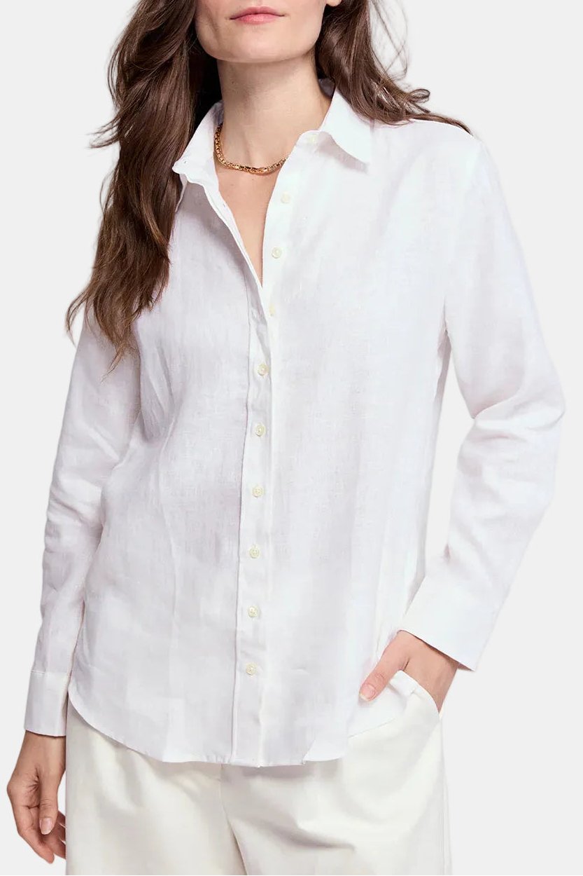 Woman wearing a white shirt against a plain background