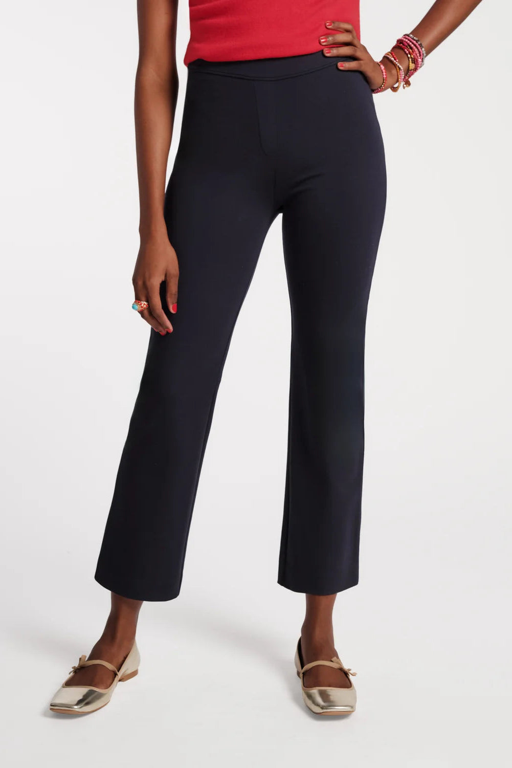 Person wearing navy blue pants on a white background