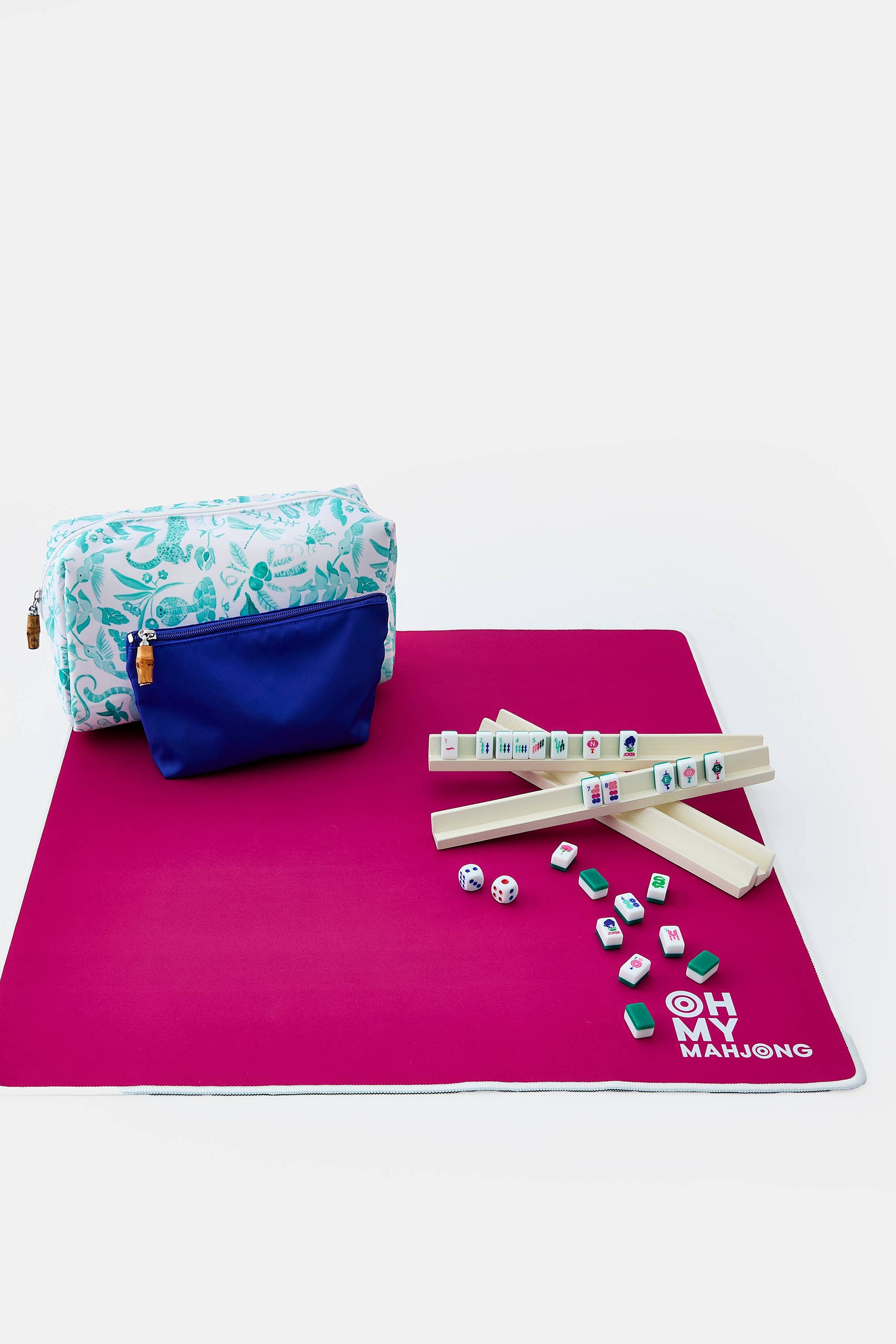 Mahjong set with tiles, sticks, and a pouch on a pink mat with 'OH MY MAHJONG' text.