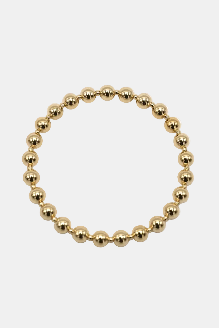 Gold beaded bracelet on a white background