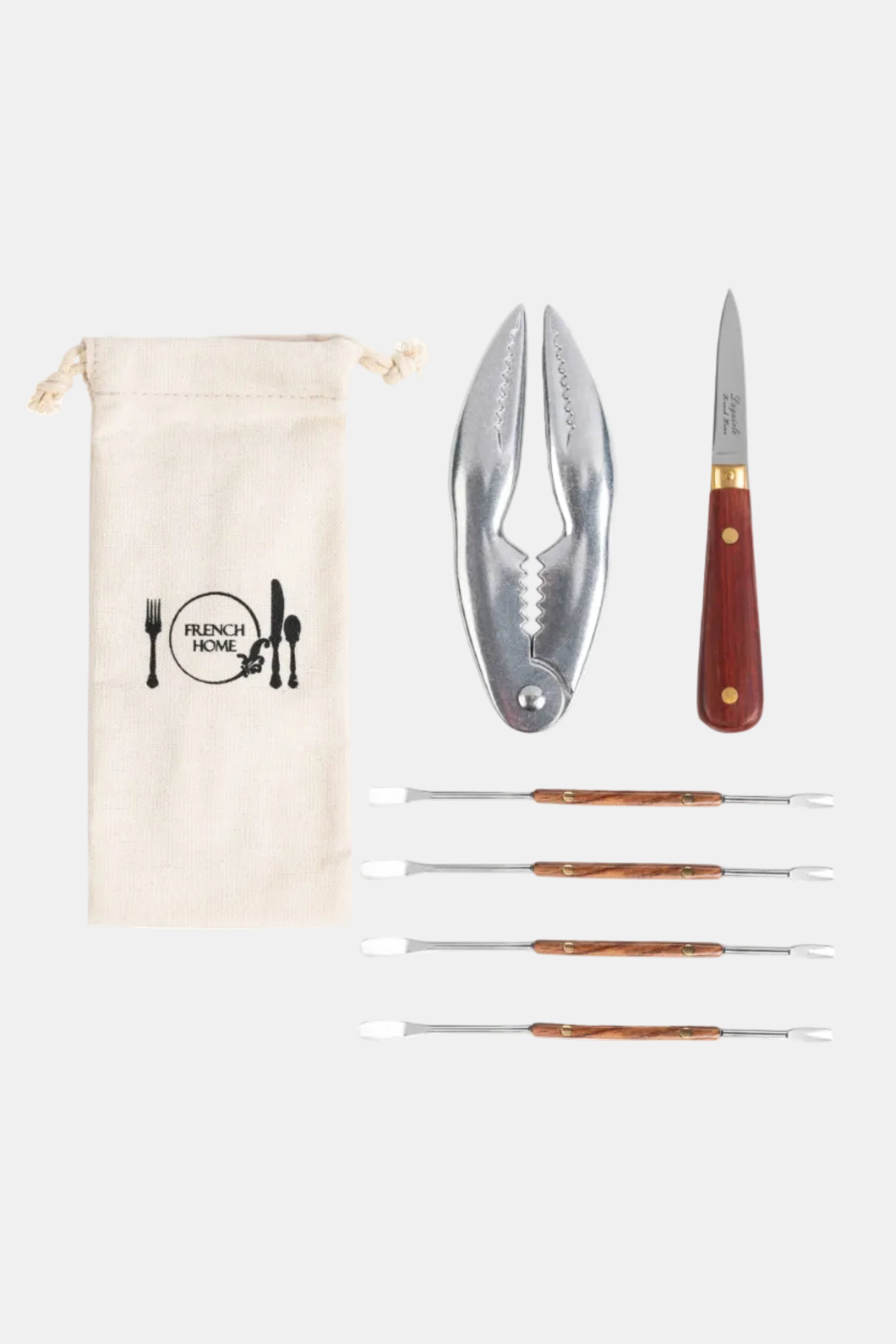 Set of kitchen tools including a cracker, skewers, and a pouch with 'French Home' branding on a white background.