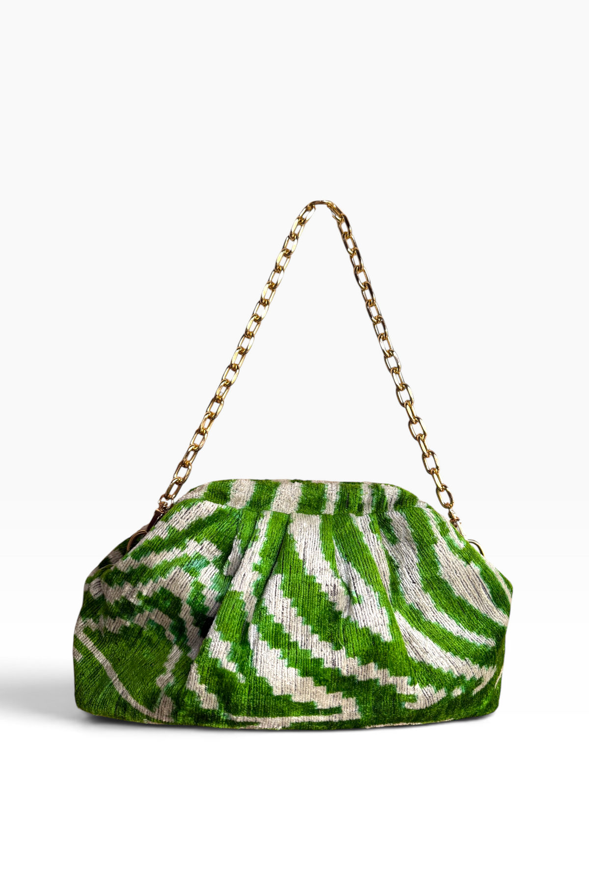 A green and white patterned woven handbag with a gold-tone chain shoulder strap, photographed on a clean white background.