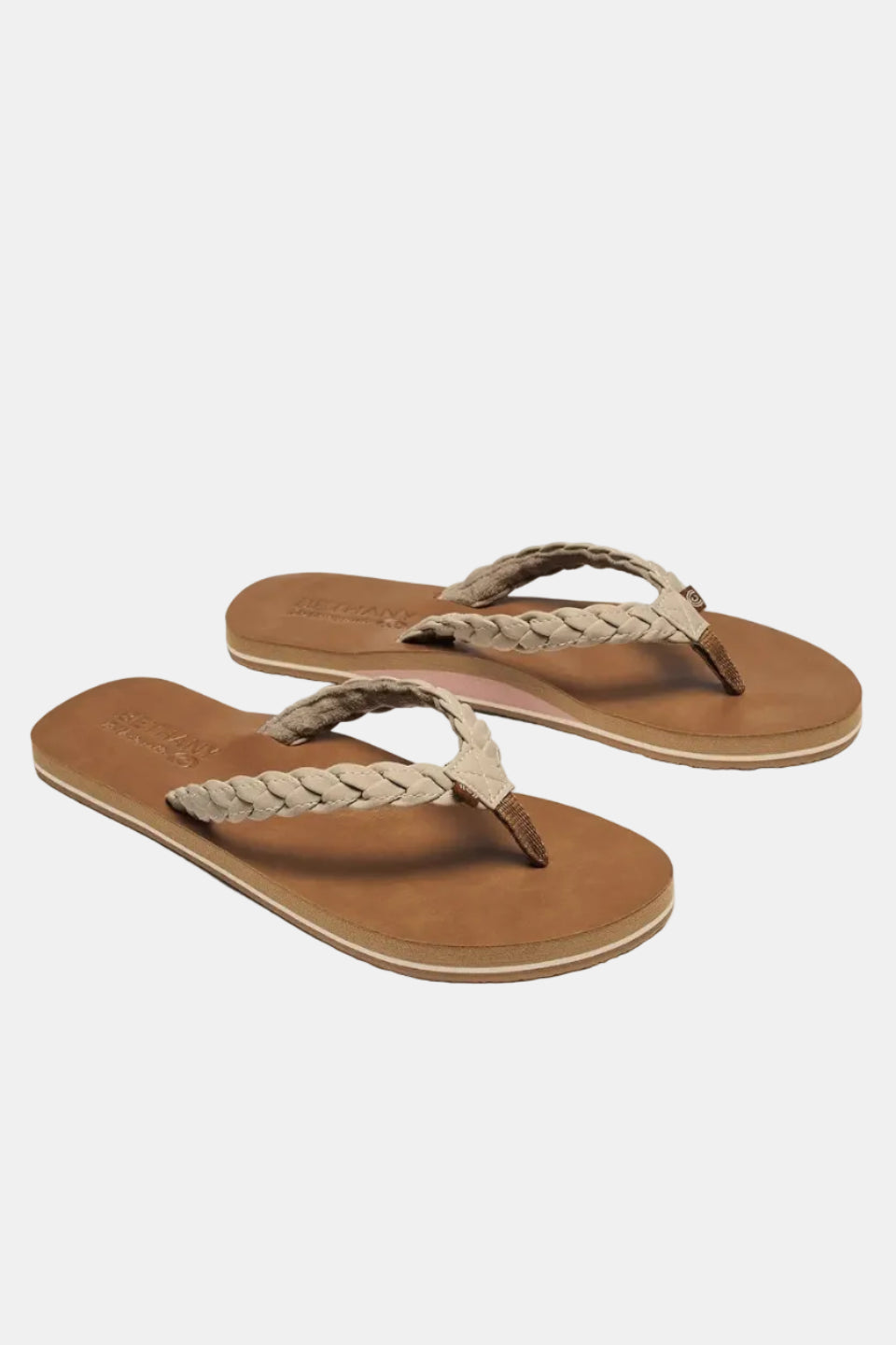 Pair of brown sandals with braided straps on a white background