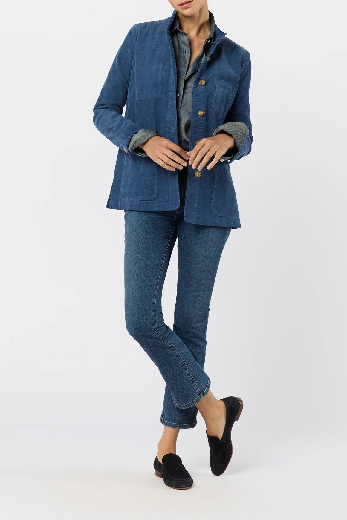 Woman wearing a blue denim suit on a white background