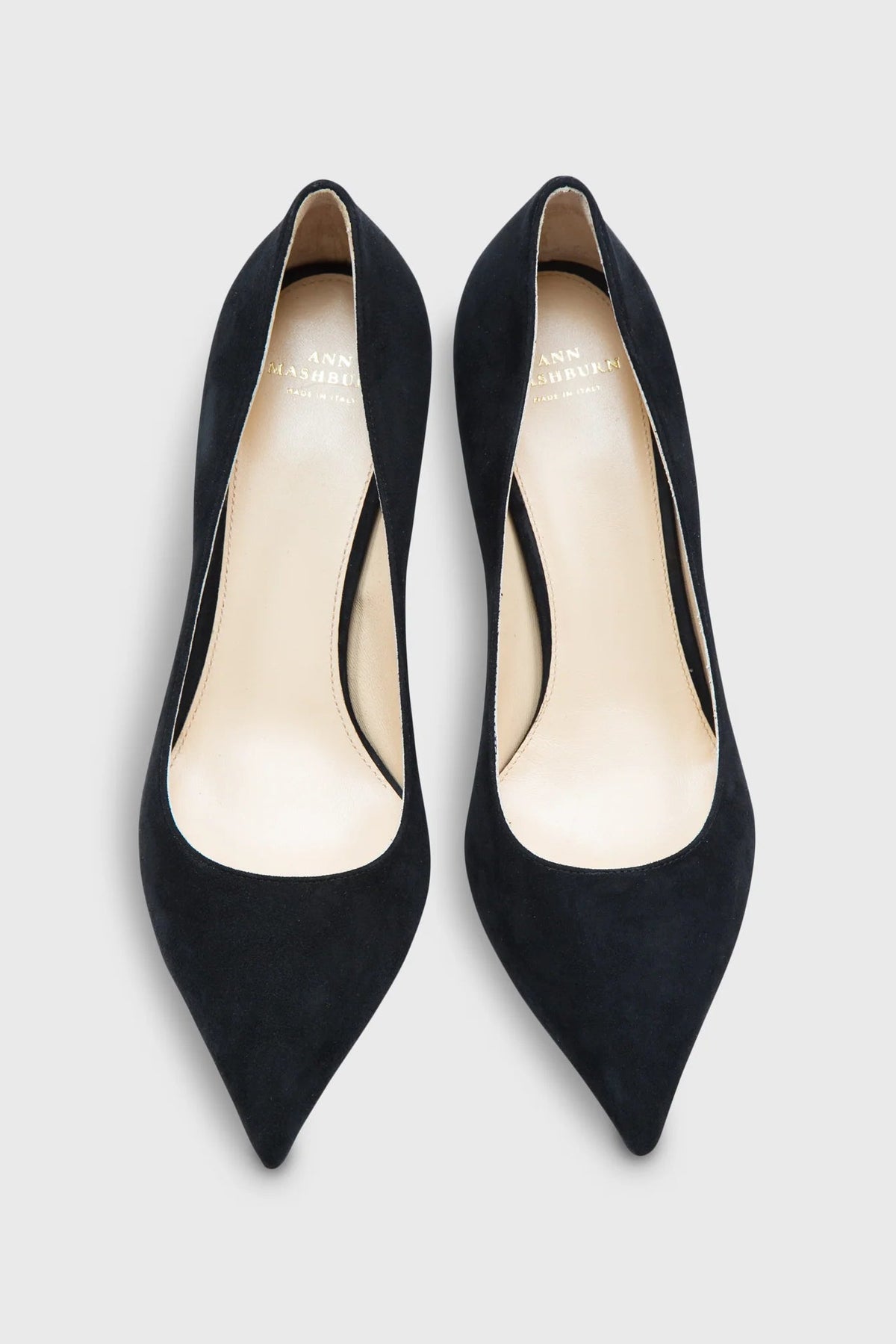 Pair of black high-heeled shoes on a light gray background