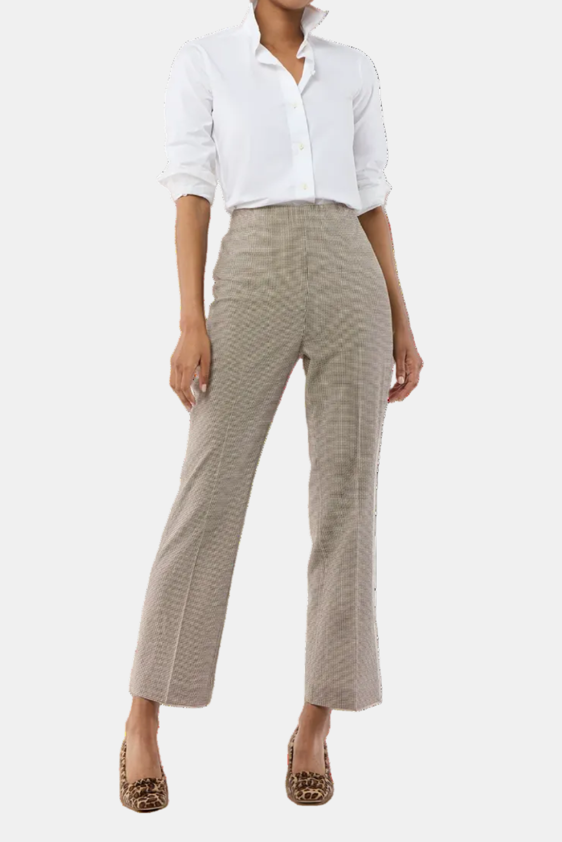 Woman wearing a white shirt and beige pants on a white background