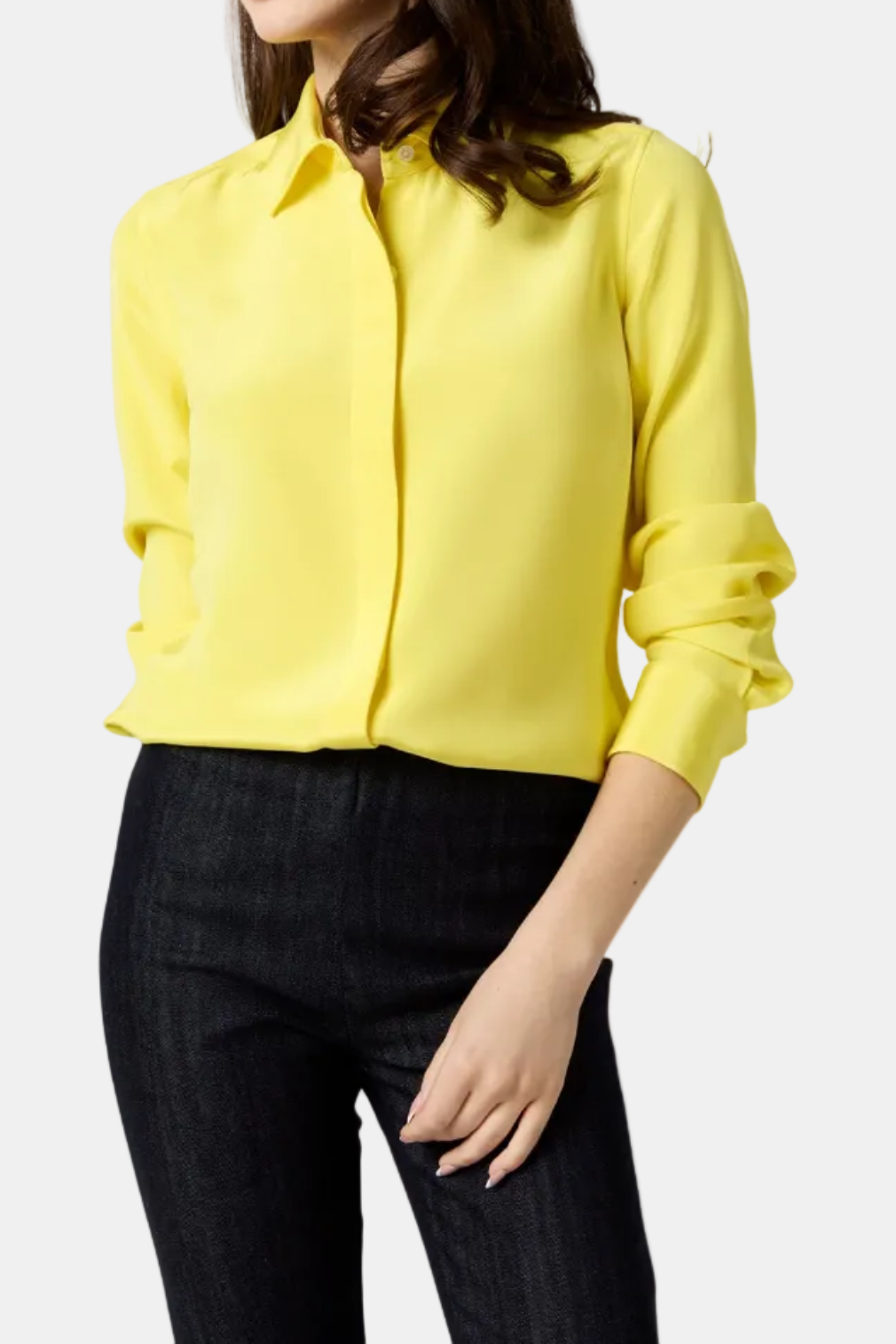 Woman wearing a yellow blouse and black pants on a white background
