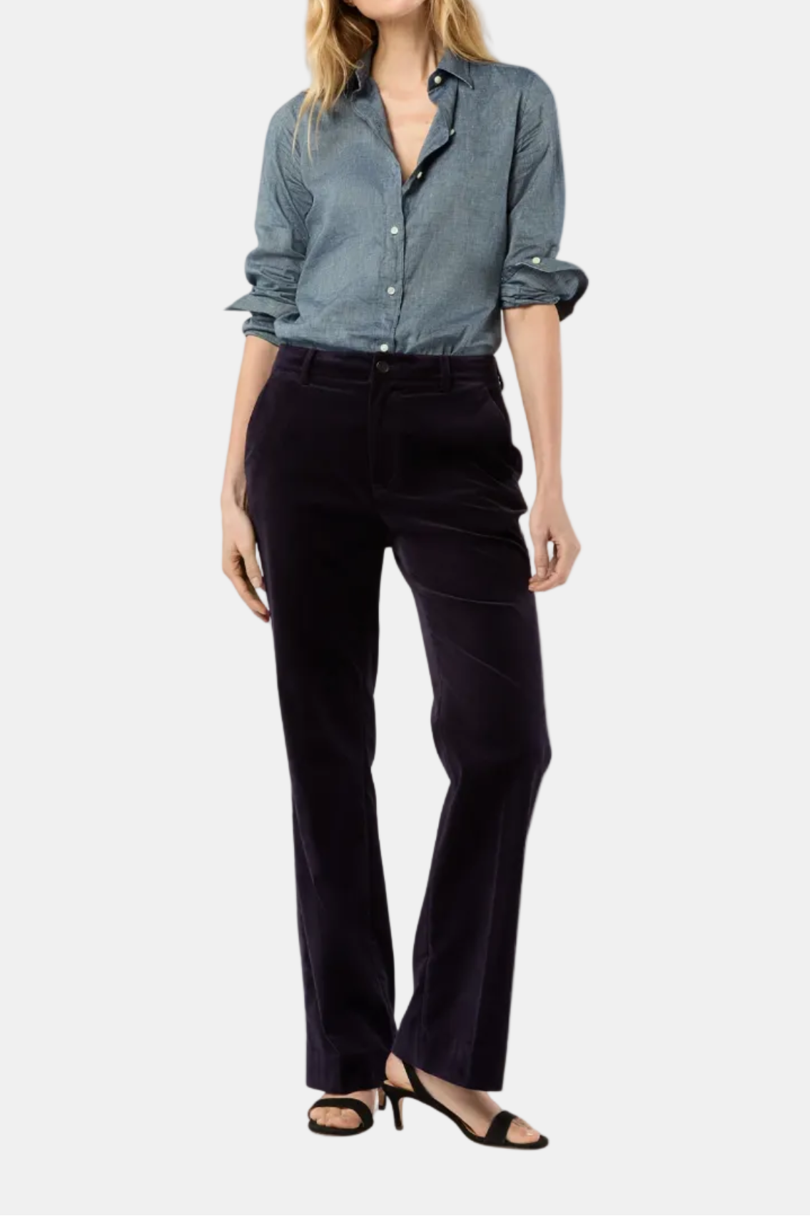 Woman wearing a blue shirt and black pants on a white background