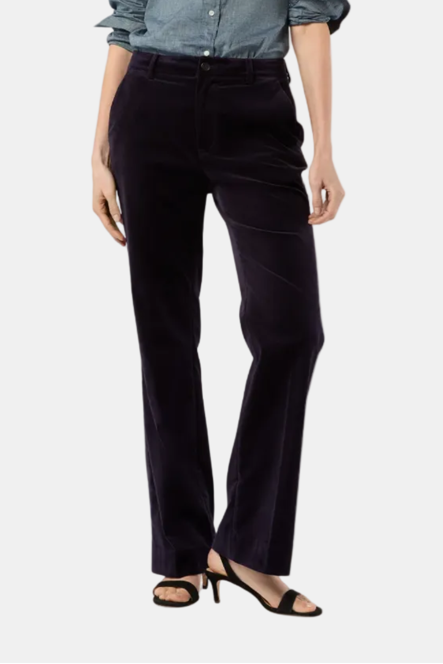 Woman wearing a blue shirt and black pants on a white background