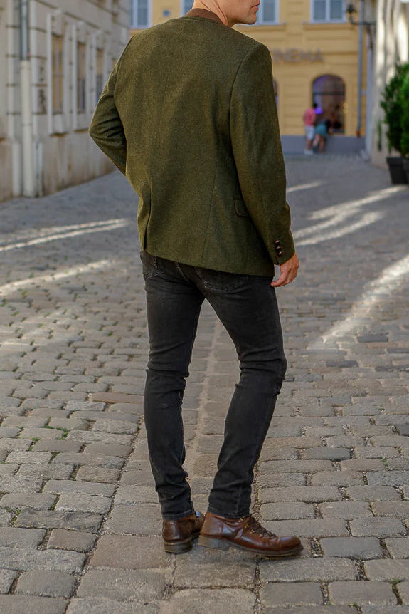 Man walking down a cobblestone street in an urban setting
