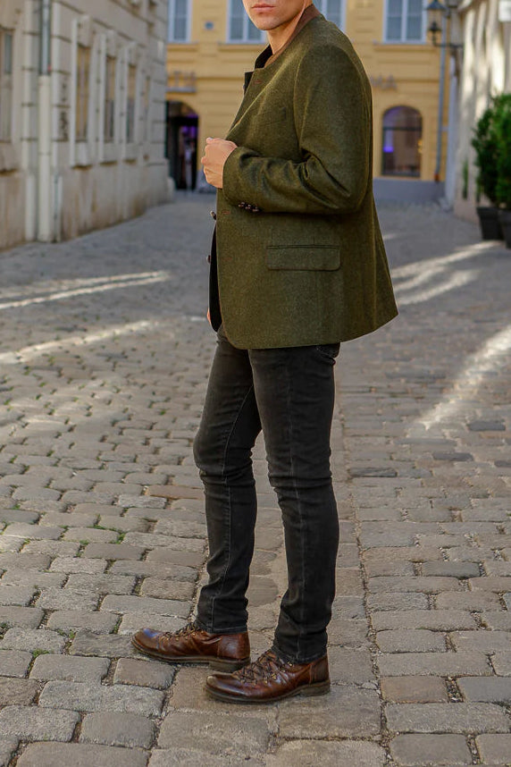 Man standing on a cobblestone street in an urban setting