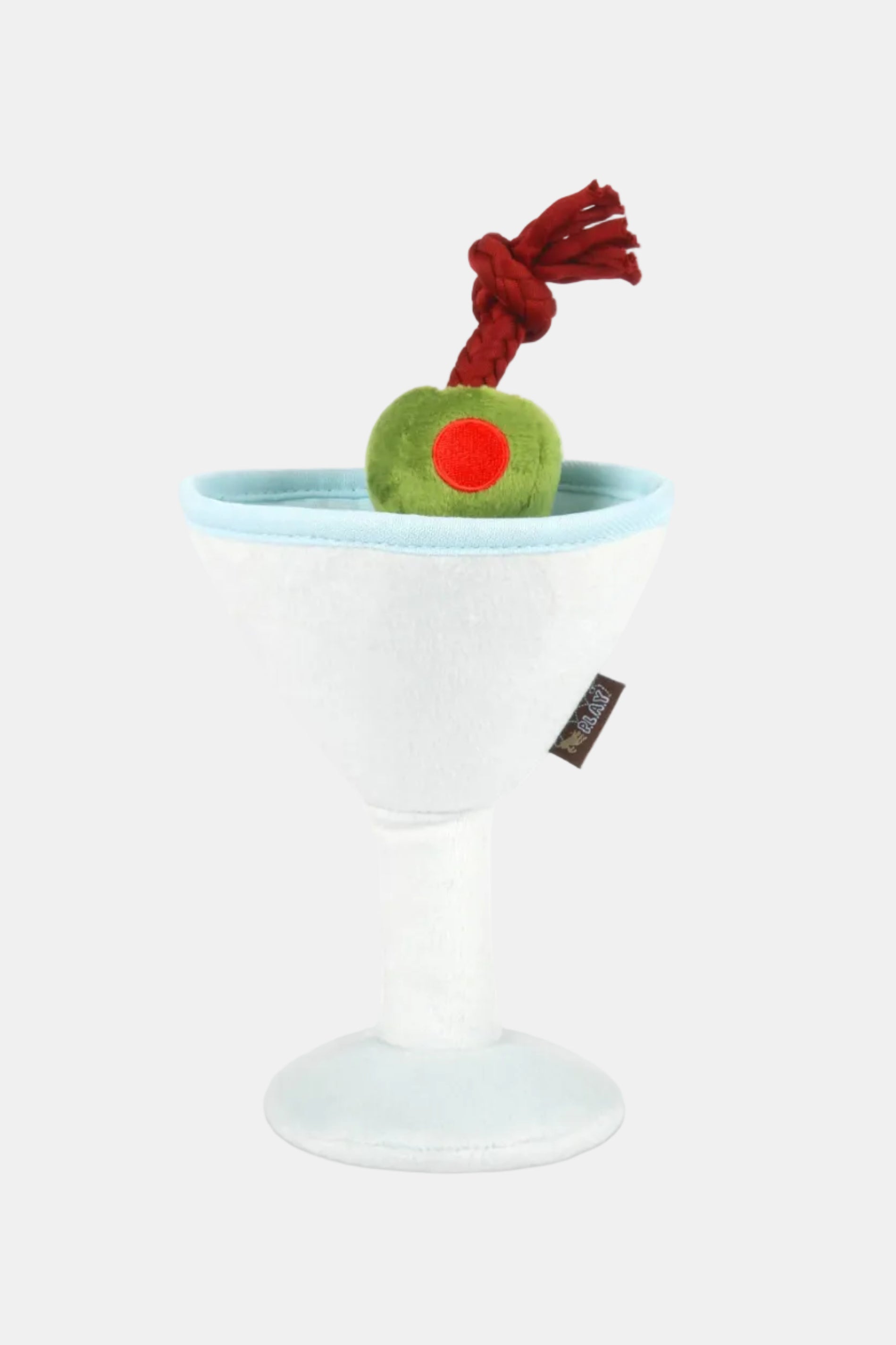 Toy resembling a cocktail with a green olive and red cherry on a white background