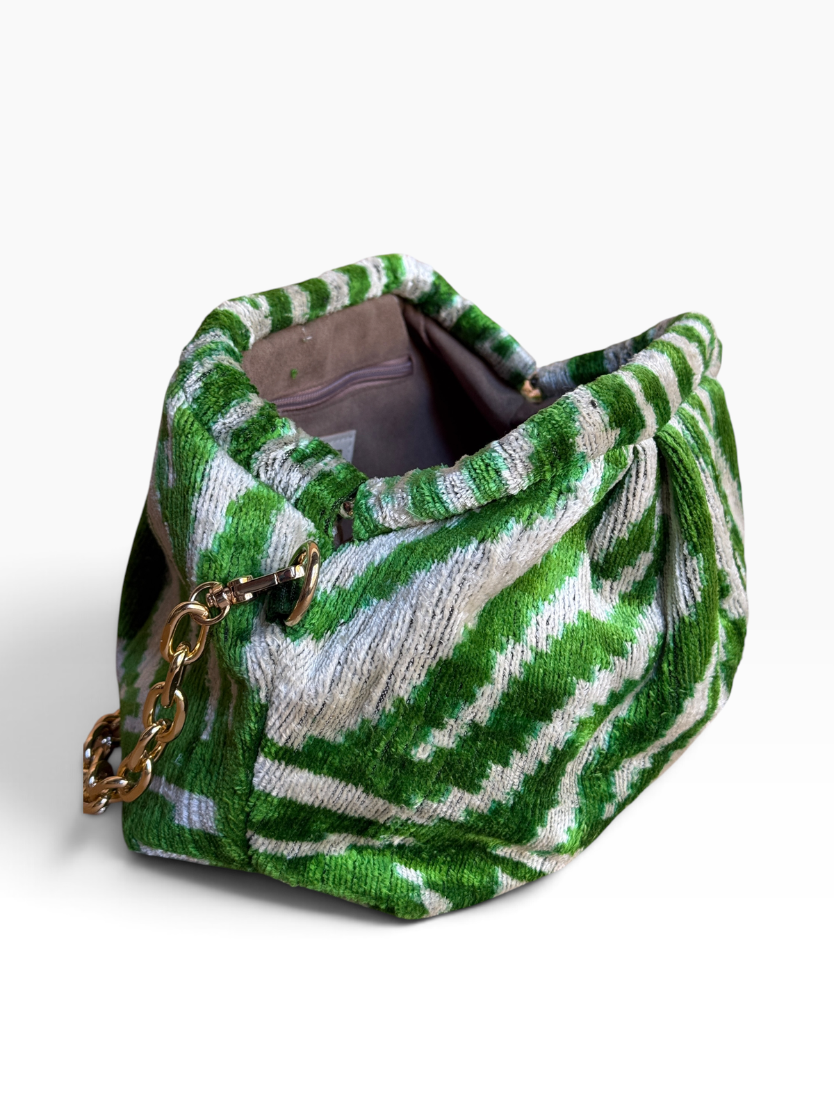 A green and white patterned fabric handbag with a gold chain strap, shown on a plain white background.
