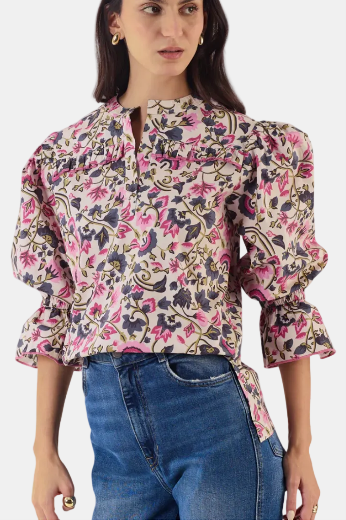 Woman wearing a floral blouse with puffed sleeves on a white background