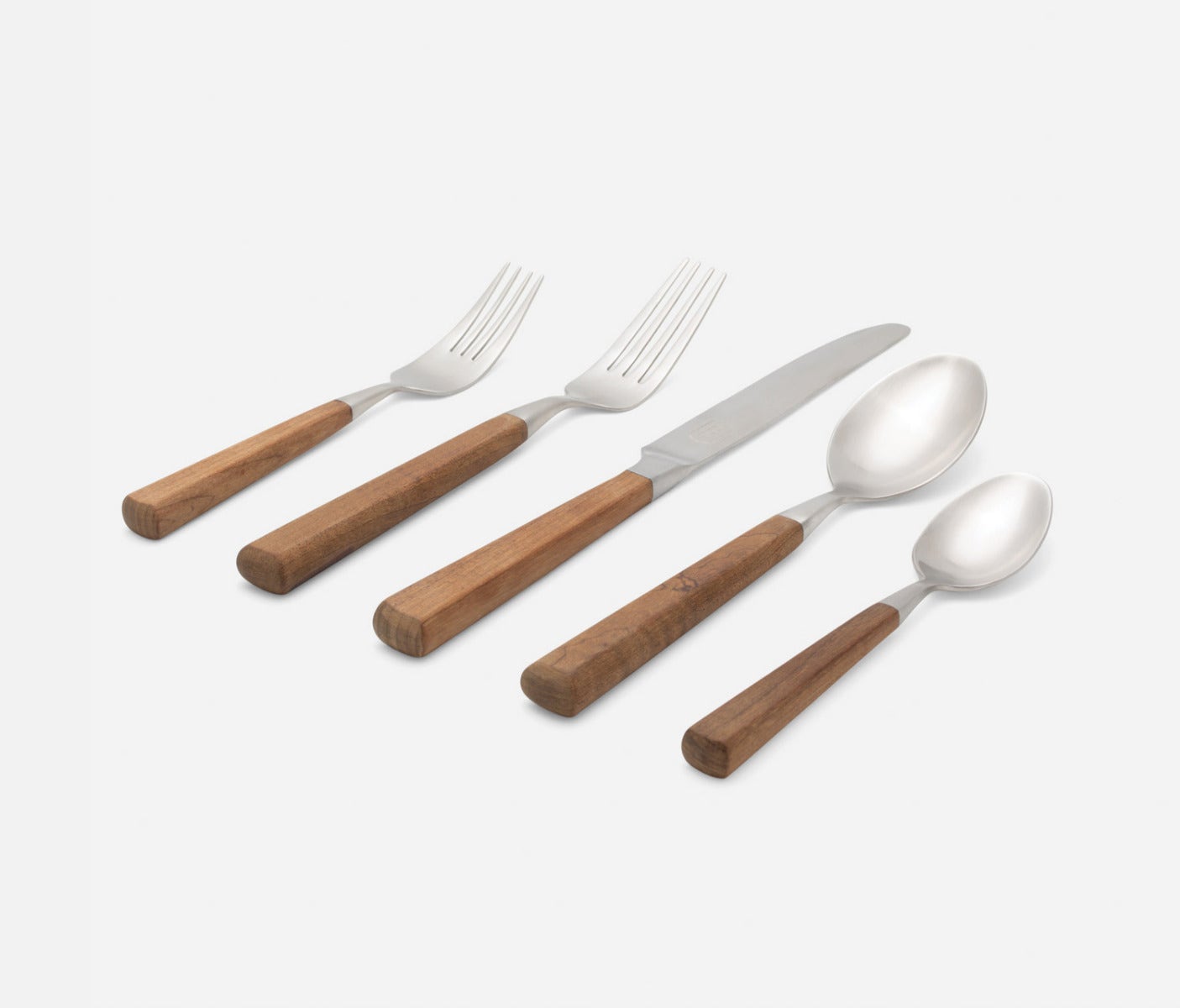 Five-piece stainless steel cutlery set with light brown wooden handles, including a fork, knife, and three spoons, arranged diagonally on a light gray background.