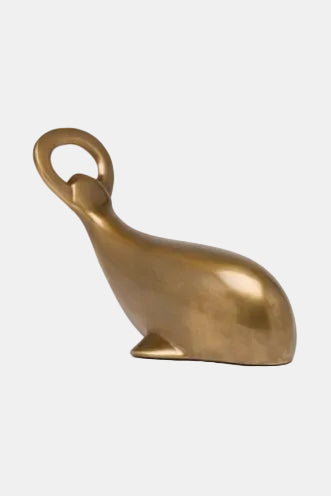 Bronze bottle opener shaped like a cat on a white background