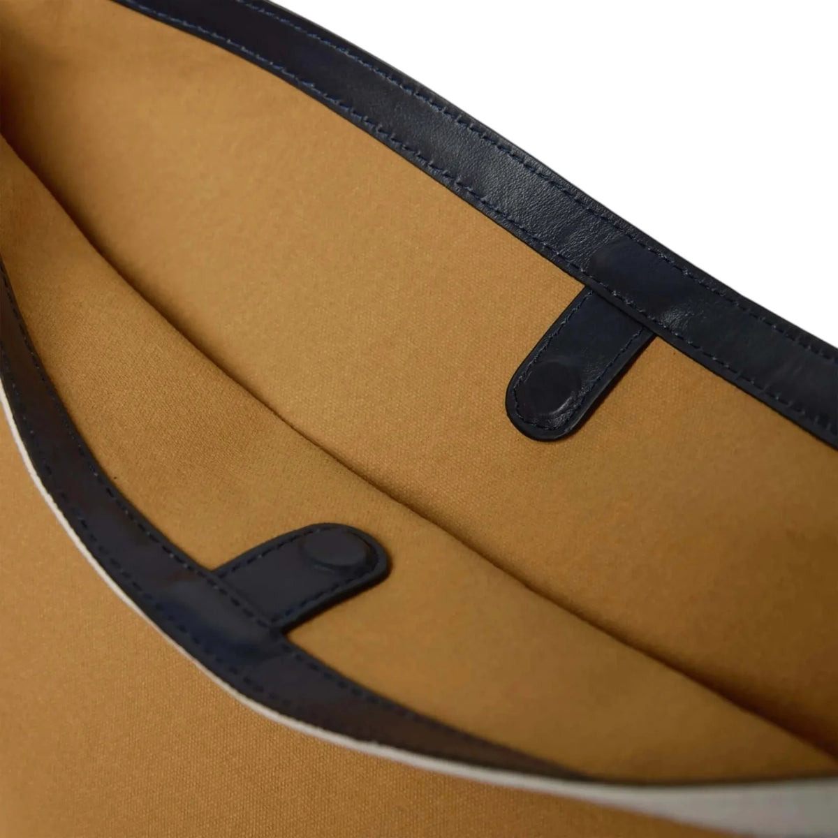 Close-up of a brown bag with black straps on a white background