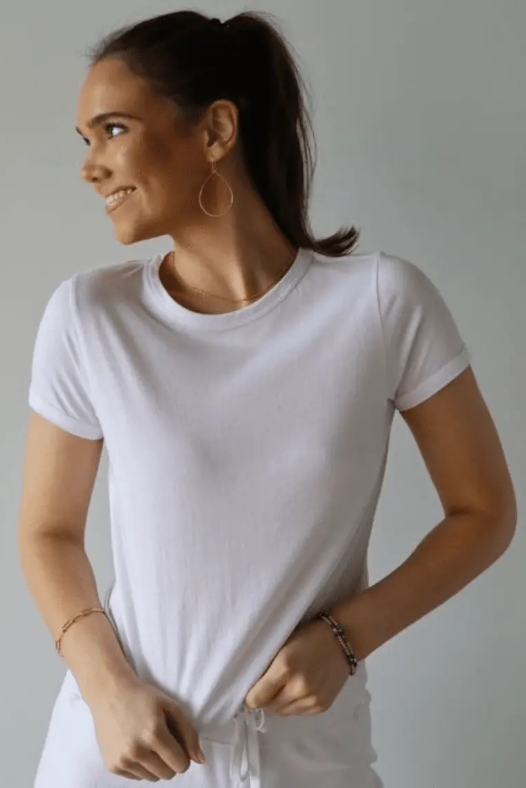 Woman wearing a plain white t-shirt against a neutral background