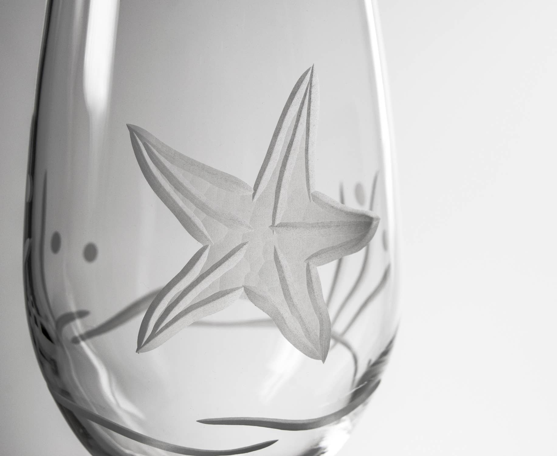 Clear glass with starfish design on a white background