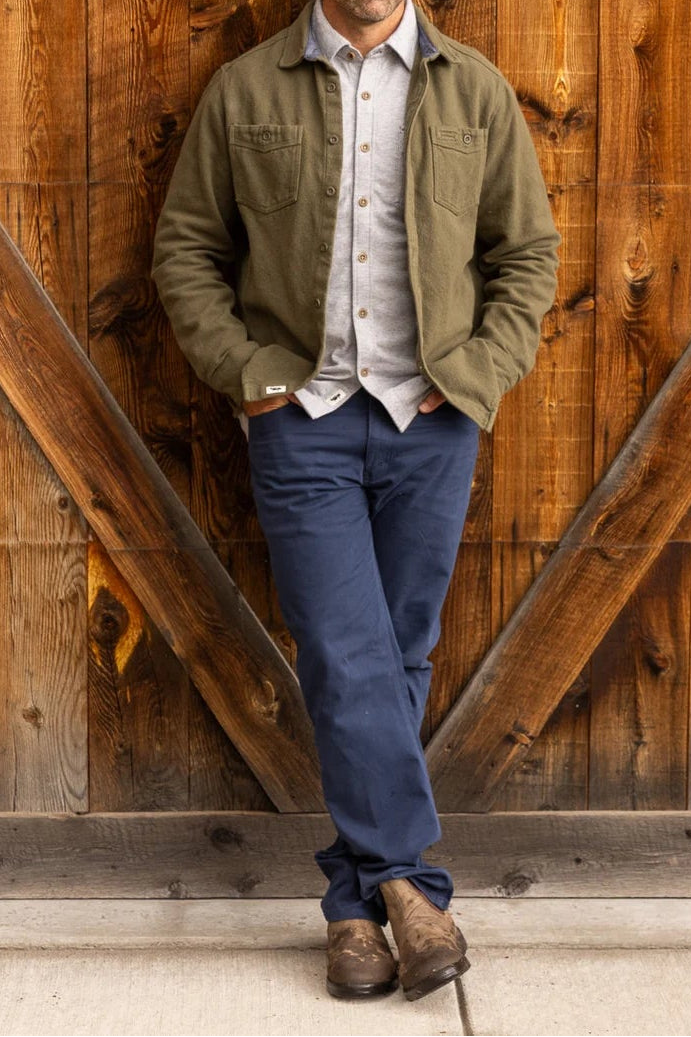 Man standing in front of a wooden gate