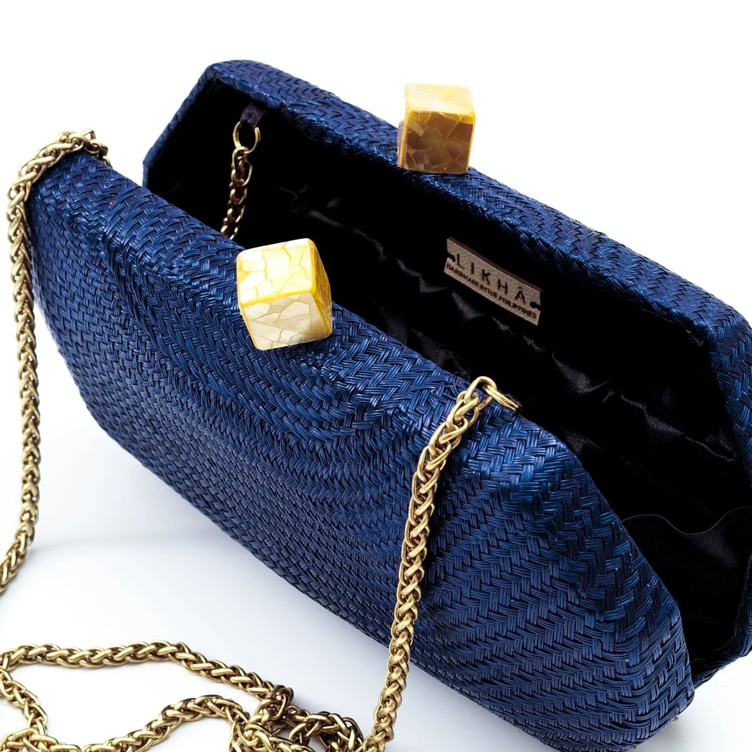 Blue clutch bag with gold chain and clasp on a white background