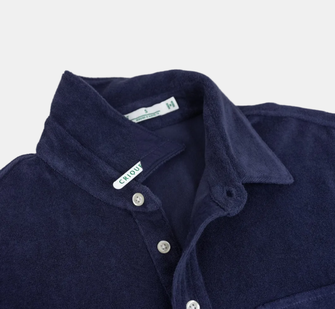 Navy blue polo shirt collar with buttons on a white background