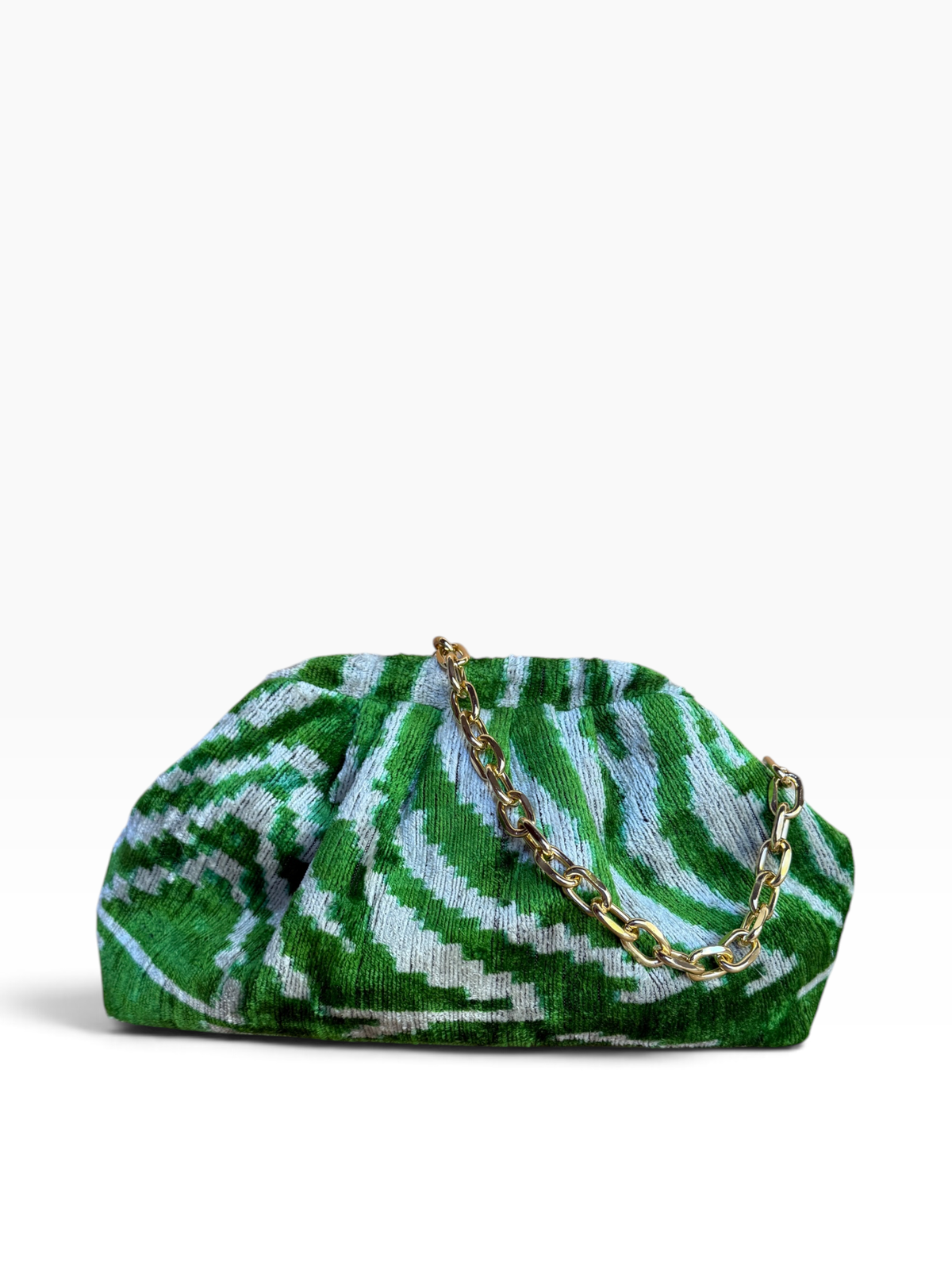 A green and white patterned clutch bag with a gold chain strap, photographed on a clean white background.