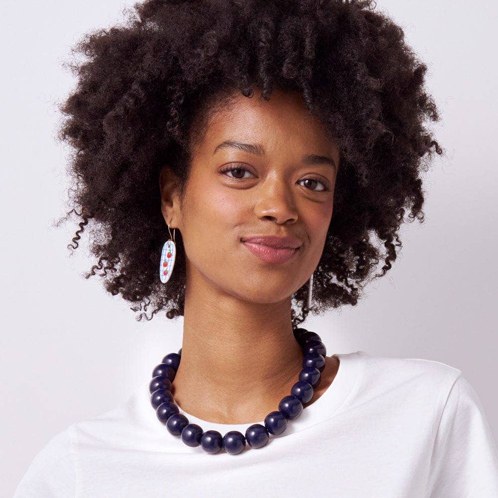 Woman wearing a necklace with a white background