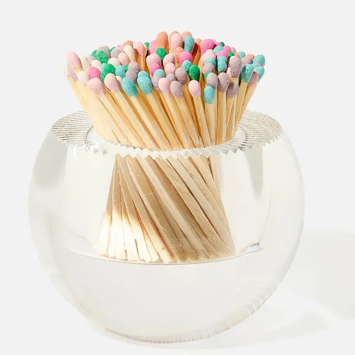 Matchstick holder with colorful matches on a white background