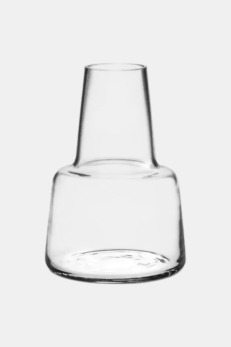 Clear glass carafe on a white background