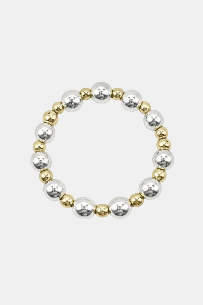 Bracelet with alternating gold and silver beads on a white background