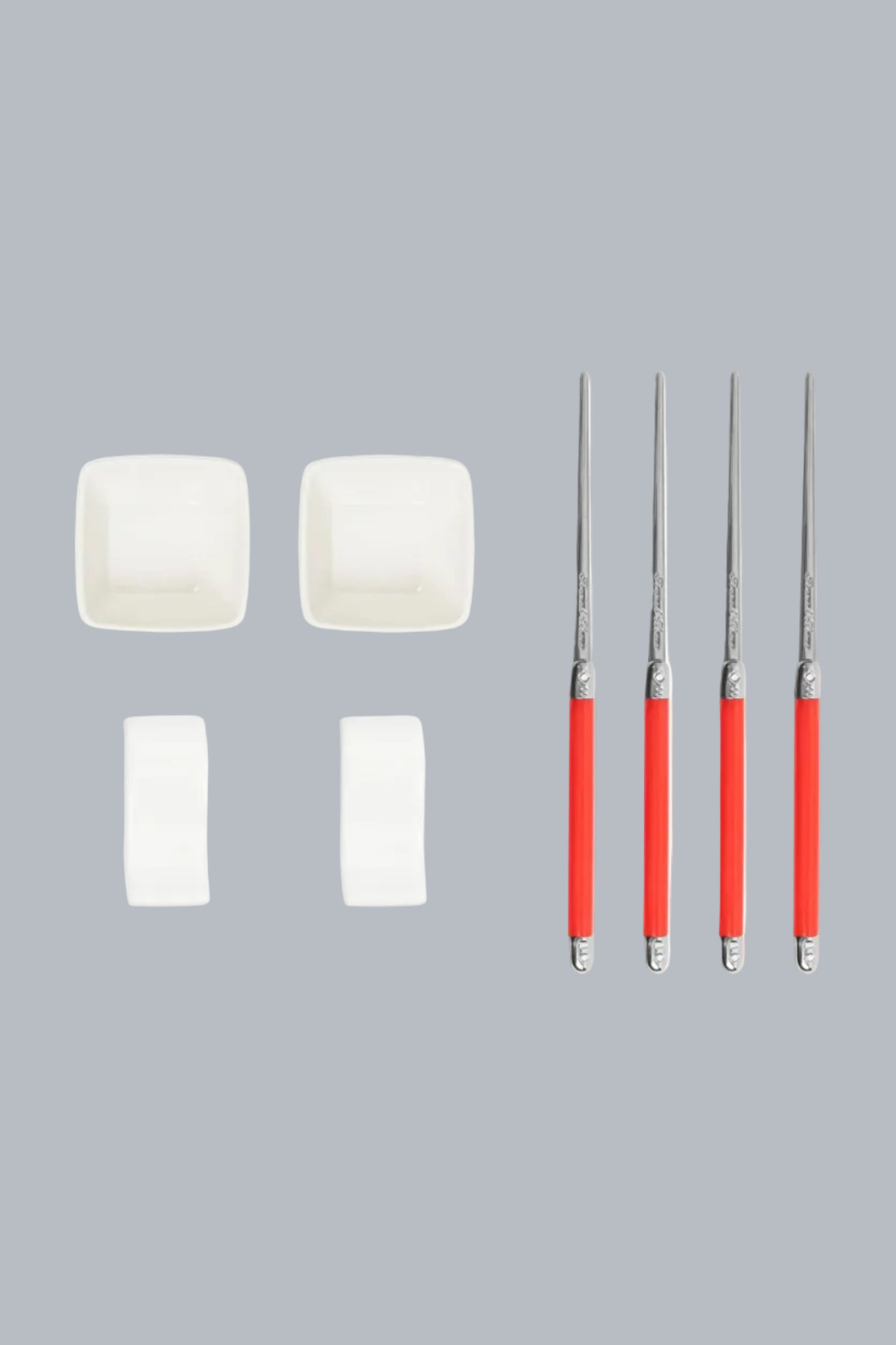 Set of four red-handled metal tools with white foam pads on a white background