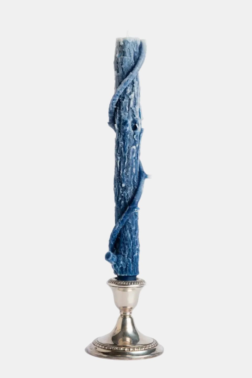 Blue candle on a silver candlestick against a white background