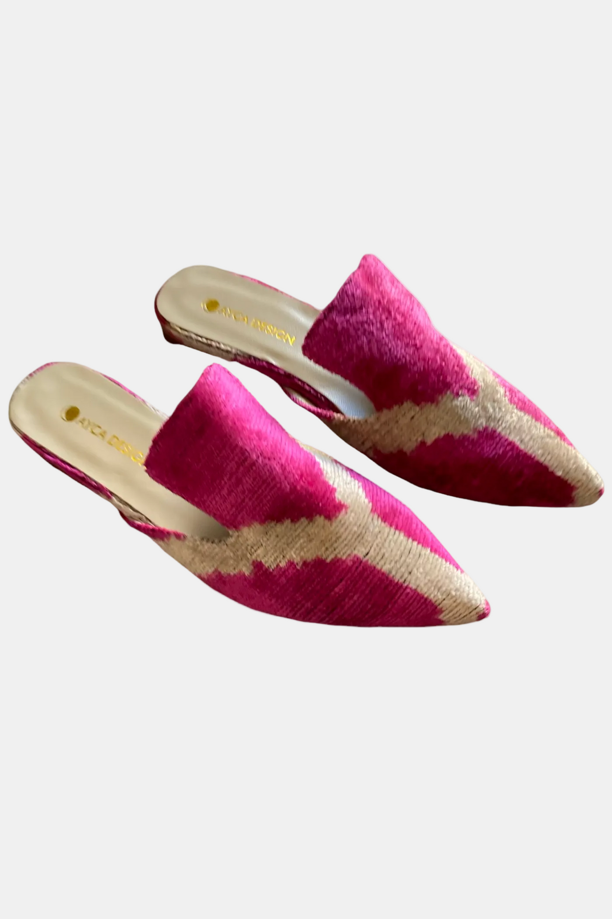 A pair of pointed-toe slip-on mule flats featuring a textured magenta pink and beige chevron pattern, shown against a plain white background.