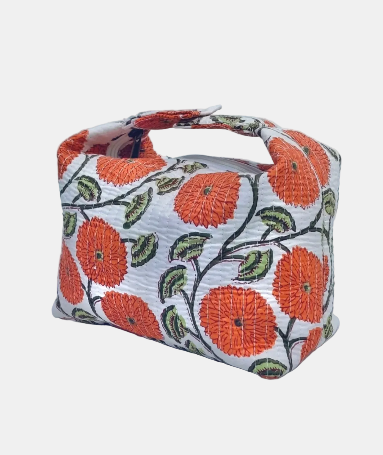 A small fabric handbag with a white background and a bold orange floral pattern, featuring dark green leaves and black stems, set against a light gray textured backdrop.