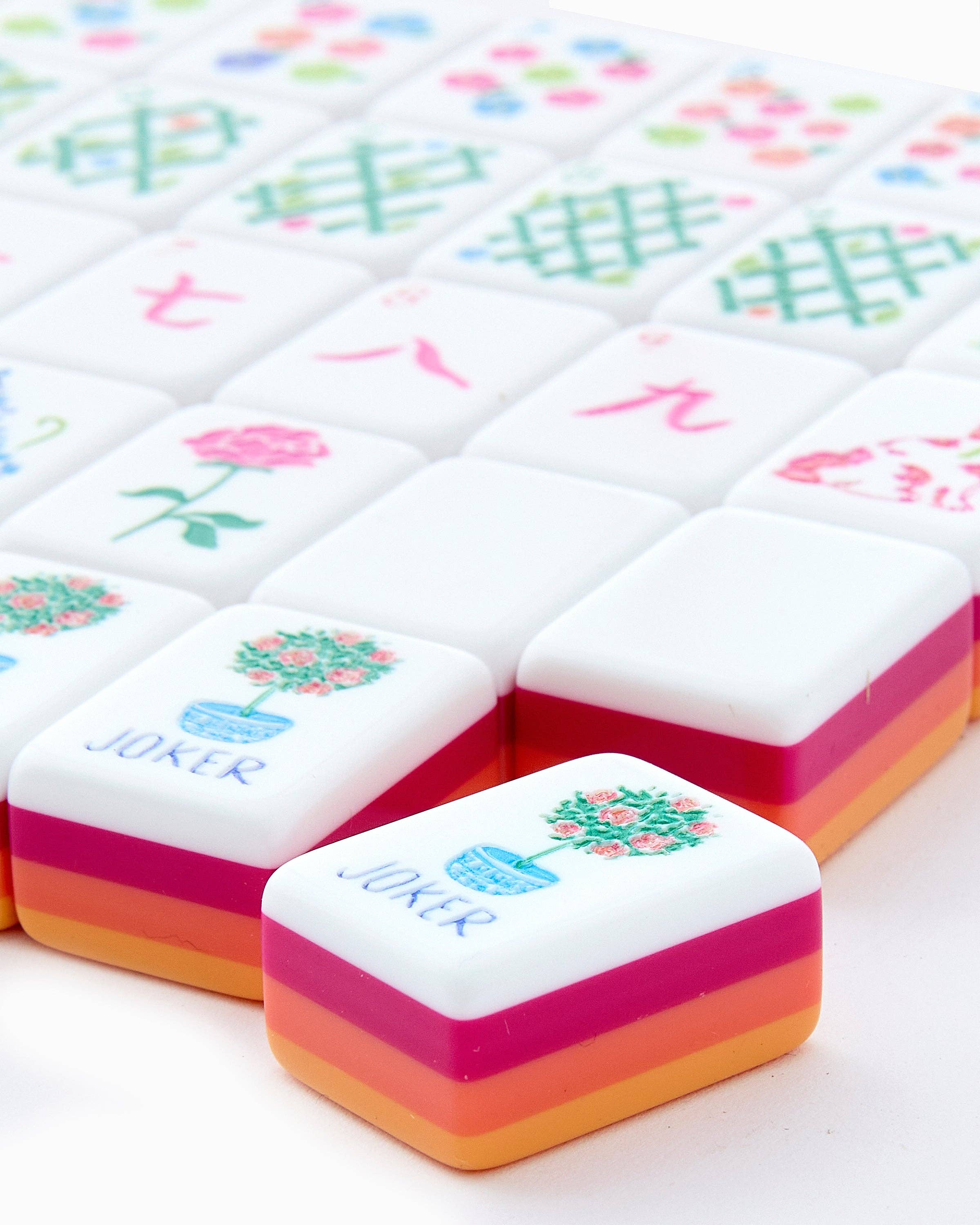 Colorful game pieces with floral designs and 'Joker' text on a white background