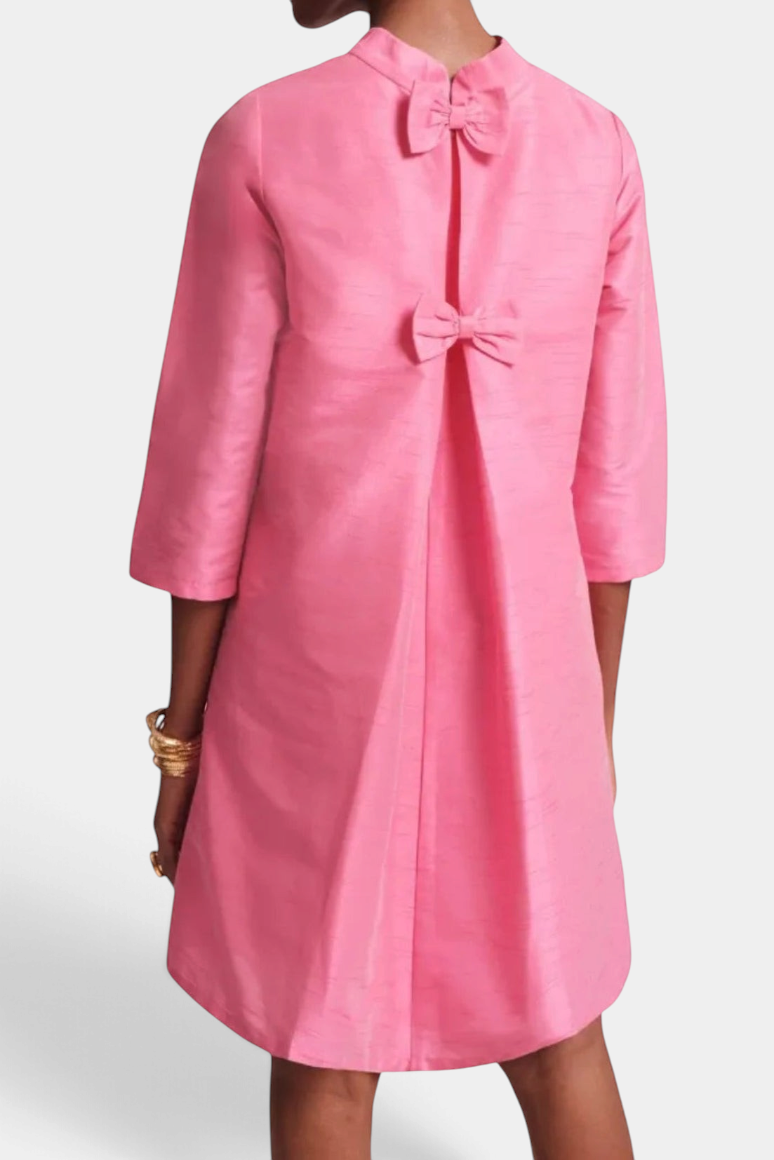 Frances Valentine pink silk A-line dress featuring a high neckline, three-quarter sleeves, and back bow details.